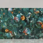 Marble slab featuring vibrant, swirling teal, blue, and copper patterns with spiral fossil-like designs.