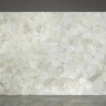 Elegant large slab of translucent white quartz with subtle beige veining against a neutral background for a modern tone.