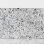 Polished white quartzite slab featuring intricate gray veining and crystal-like patterns.