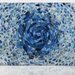 Abstract artwork with a swirling pattern of blue tones and overlapping oval shapes creating fluid movement.