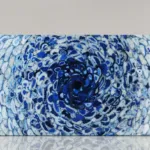 Abstract artwork featuring swirling blue and white patterns resembling a whirlpool, conveying movement and depth.