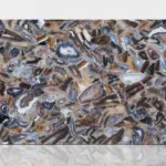 Polished slab featuring an earthy brown, gray, and white agate stone mosaic, creating a dynamic abstract pattern.