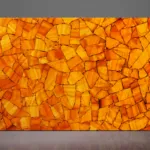 Backlit orange calcite slab with gold accents