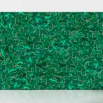 Green malachite-patterned surface with swirling textures, rich emerald shades, and light veins against a plain backdrop.