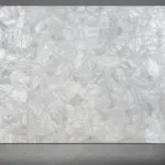 Large rectangular translucent white crystal slab with a textured, multifaceted surface reflecting light.