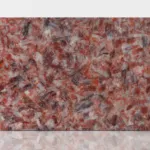 Polished stone slab featuring intricate red, pink, and gray swirls against a white background for a rich texture.