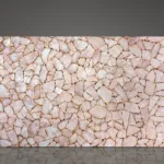 Backlit pink quartz slab with gold accents