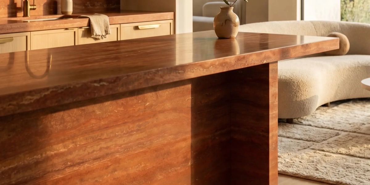 Travertino Rosso kitchen island in warm winter light.